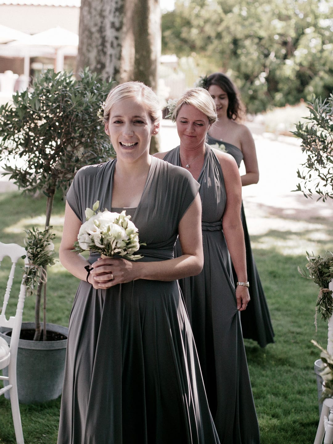 My bridesmaids walking up the aisle in sage green dresses